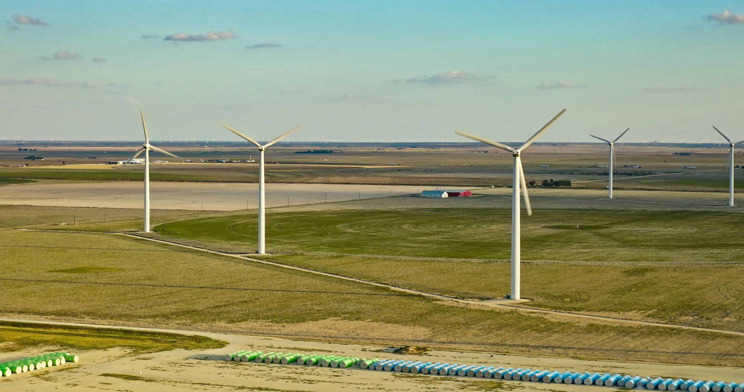 Wind turbines and agricultural fields representing primary industries